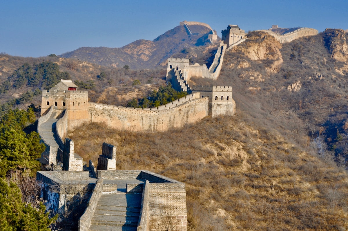 Jinshanling Great Wall at sunrise — the wall snakes along mountain ridges with 67 watchtowers, the densest concentration of any section