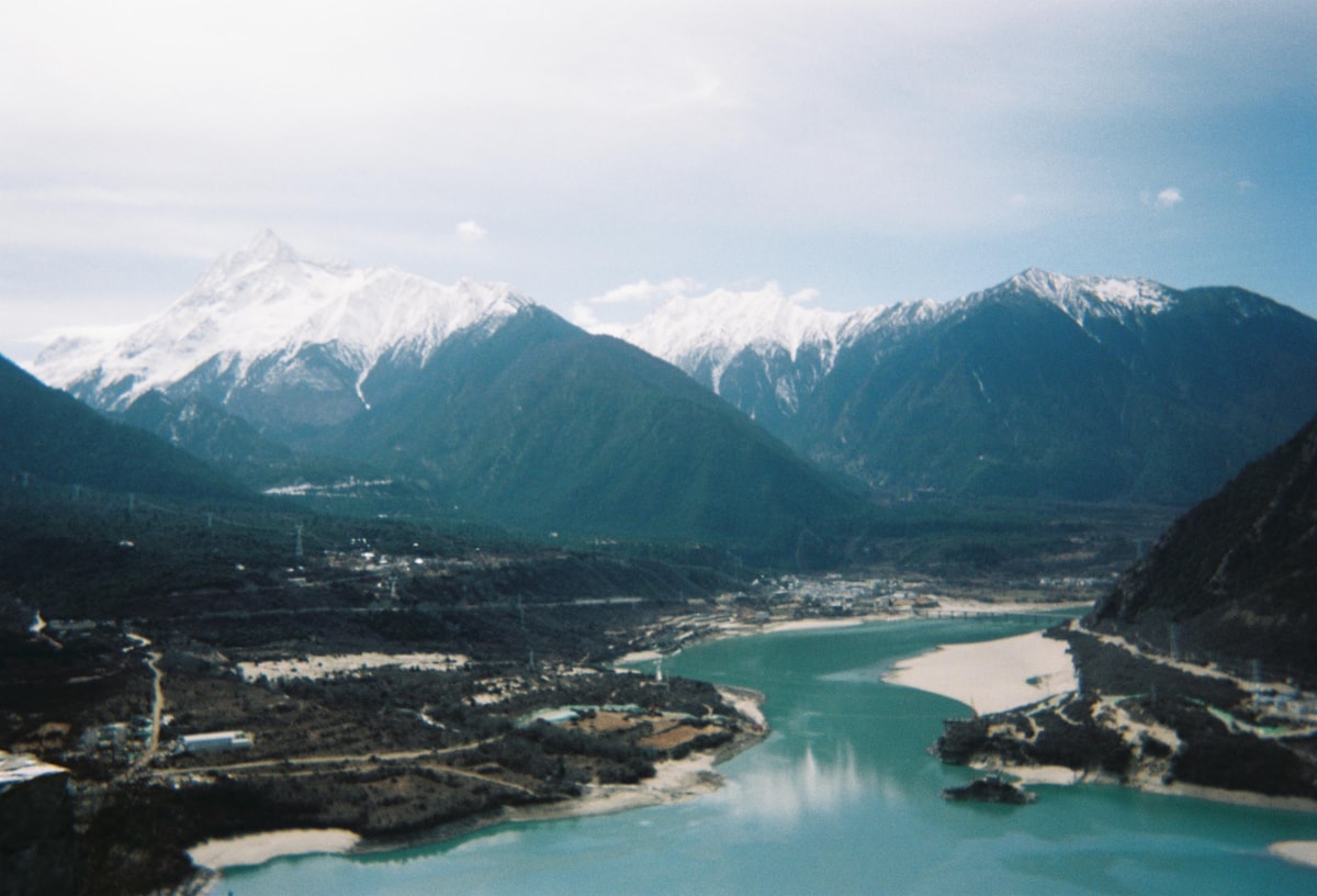 Yamdrok Lake seen from above — turquoise water winding through barren Tibetan mountains at 4,441 meters