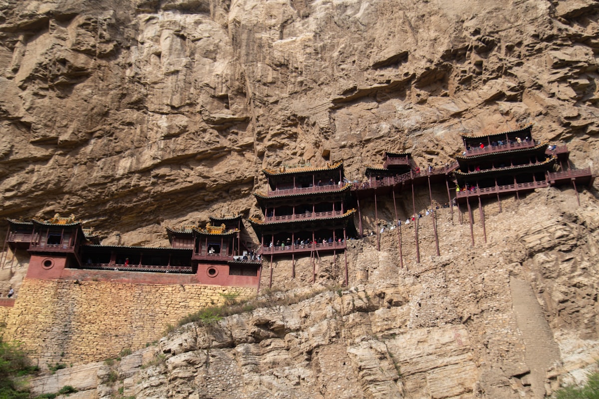 Ancient temple buildings built into a vertical cliff face in Shanxi, China