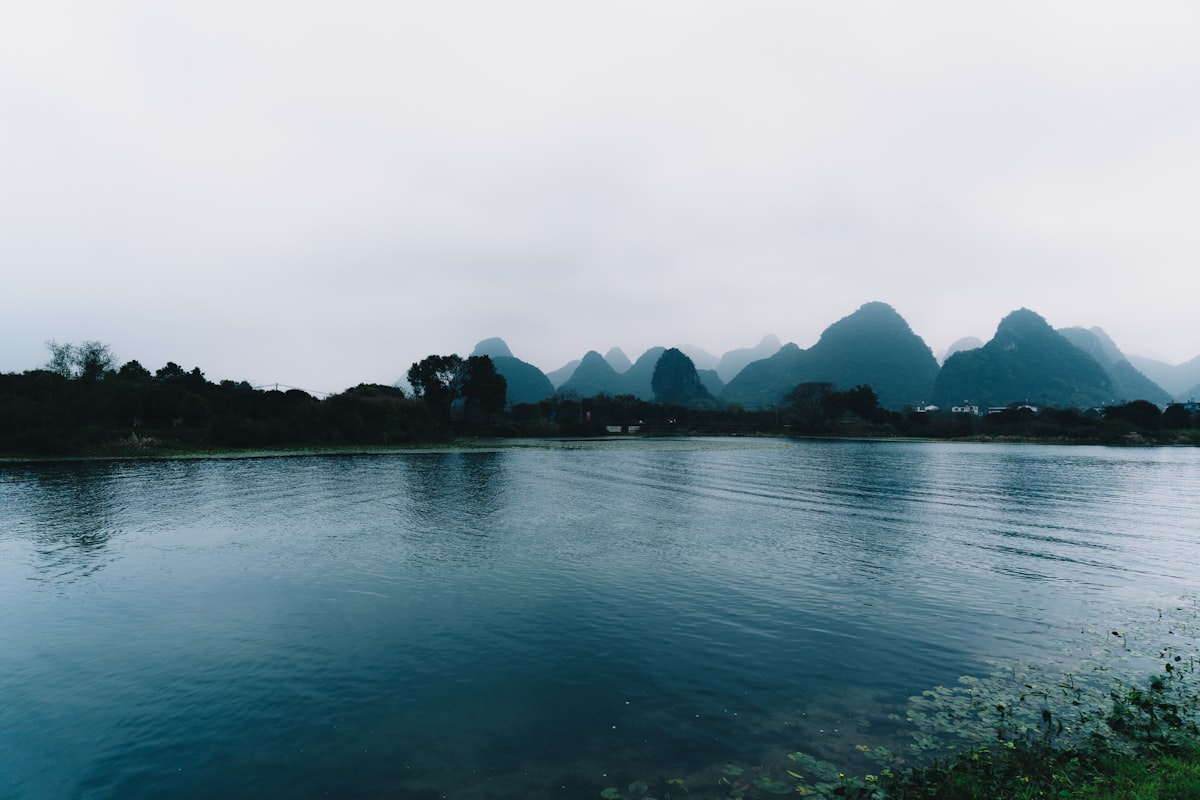 Fuli Bridge — a 500-year-old Ming Dynasty stone arch bridge forming a perfect circle with its reflection in the still Yulong River